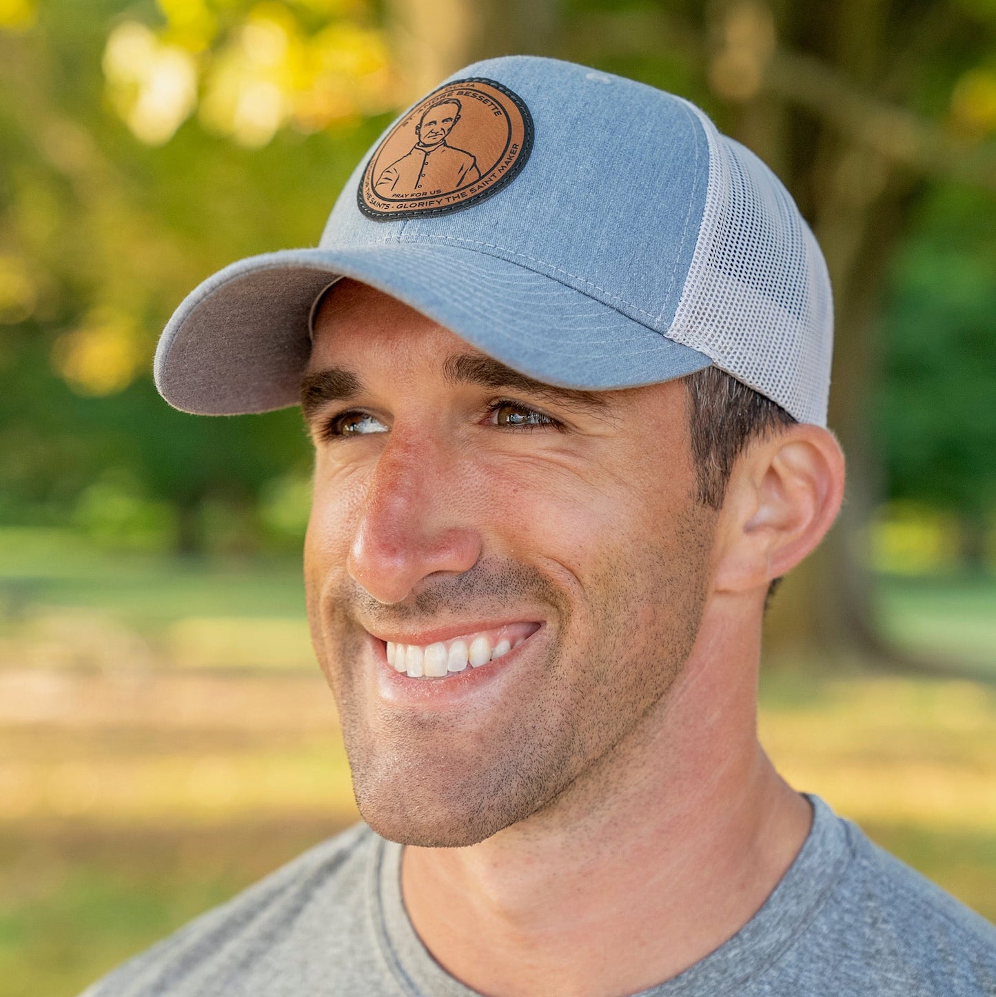 Leather patch trucker hat with St Andre Bessette