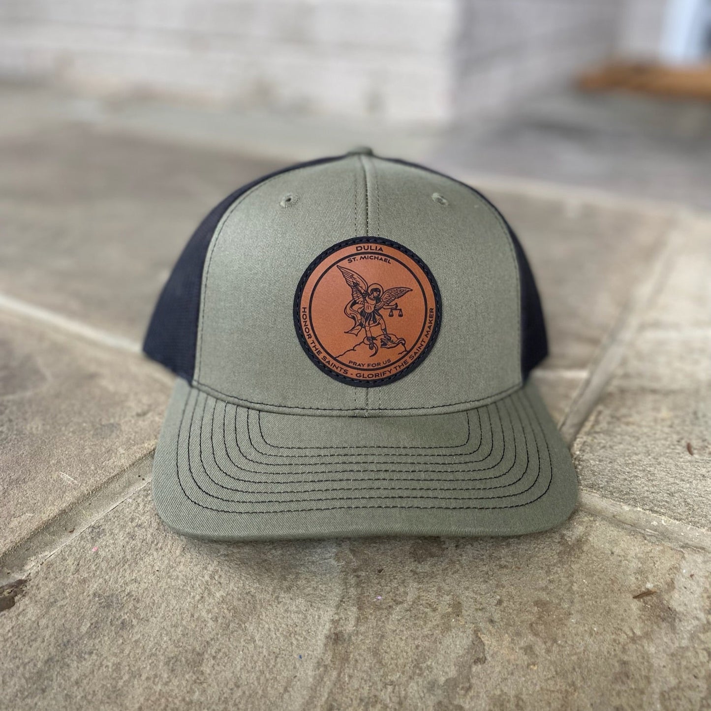 Leather patch trucker hat with St Michael