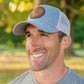 Leather patch trucker hat with St Andre Bessette