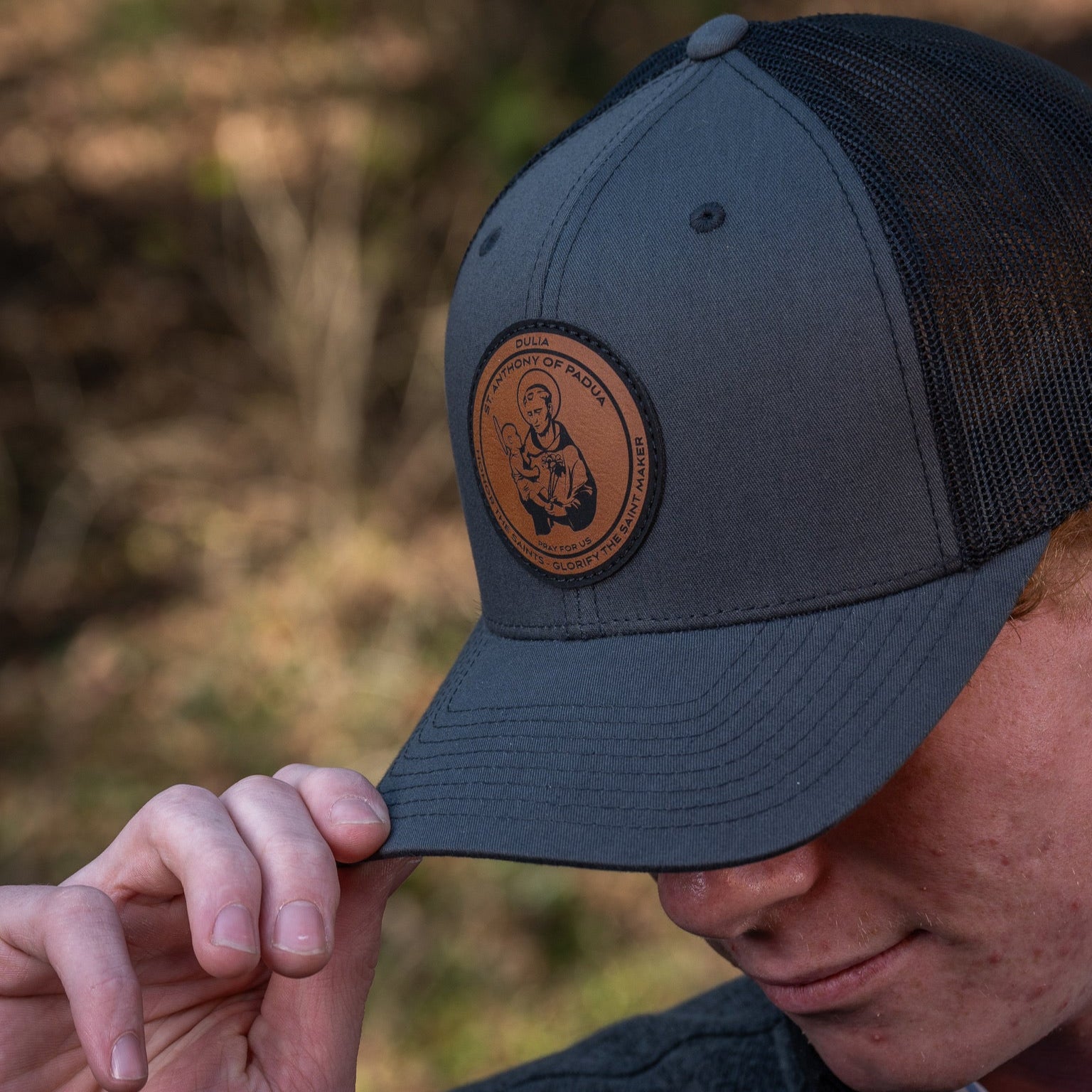 Leather patch trucker hat with St Anthony