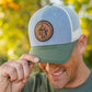 Leather patch trucker hat with St Francis of Assisi